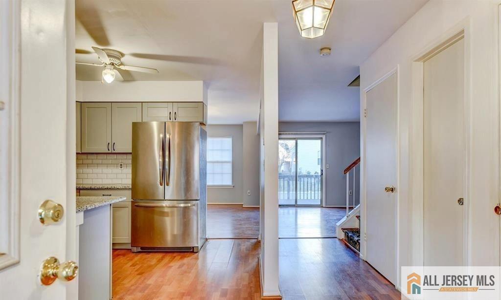 115 Salem Road North Brunswick, NJ 08902 - Photo 3 of 24 a view of a kitchen with a refrigerator and wooden floor