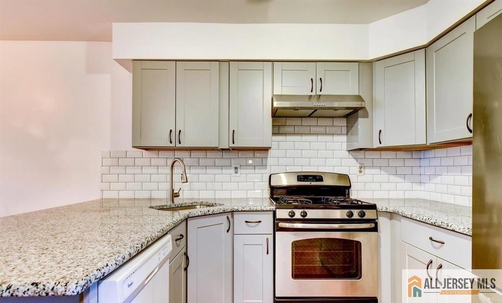 115 Salem Road North Brunswick, NJ 08902 - Photo 4 of 24 a kitchen with stainless steel appliances granite countertop a stove and a white cabinets