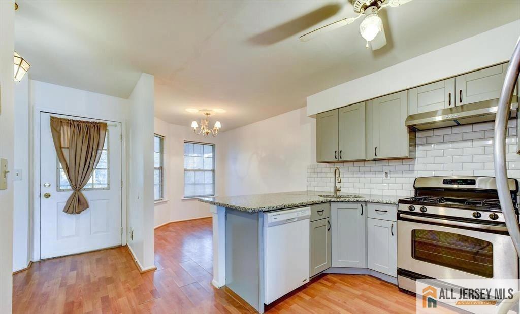 115 Salem Road North Brunswick, NJ 08902 - Photo 5 of 24 a kitchen with granite countertop a sink cabinets and stainless steel appliances