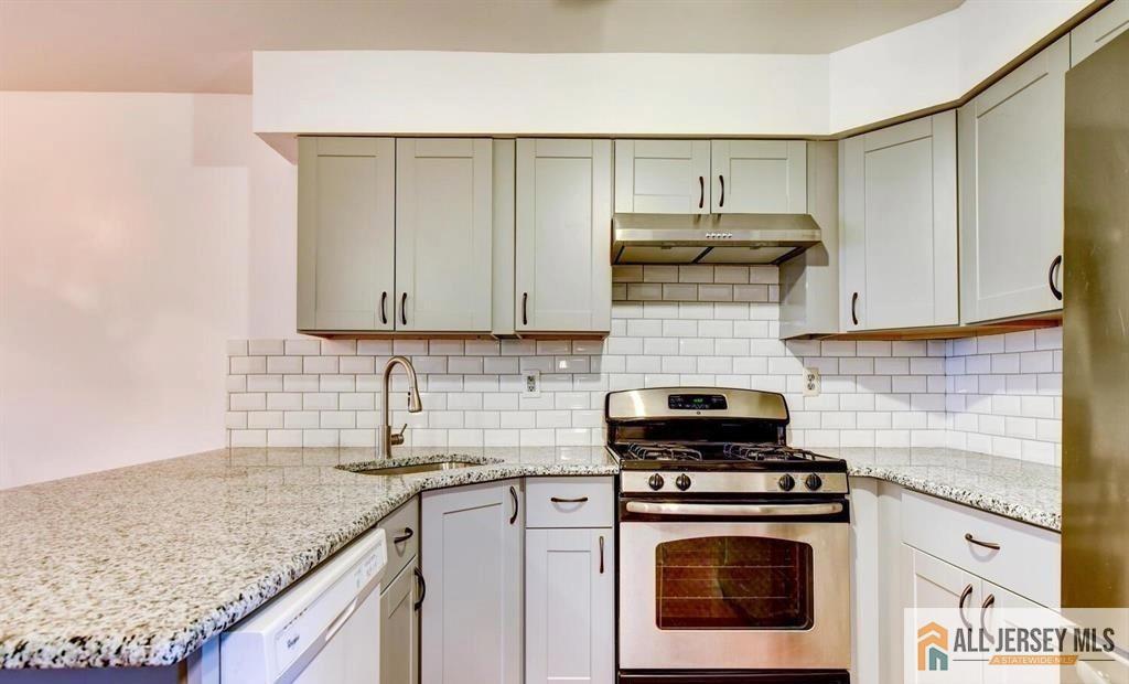 115 Salem Road North Brunswick, NJ 08902 - Photo 6 of 24 a kitchen with stainless steel appliances granite countertop a stove and a white cabinets