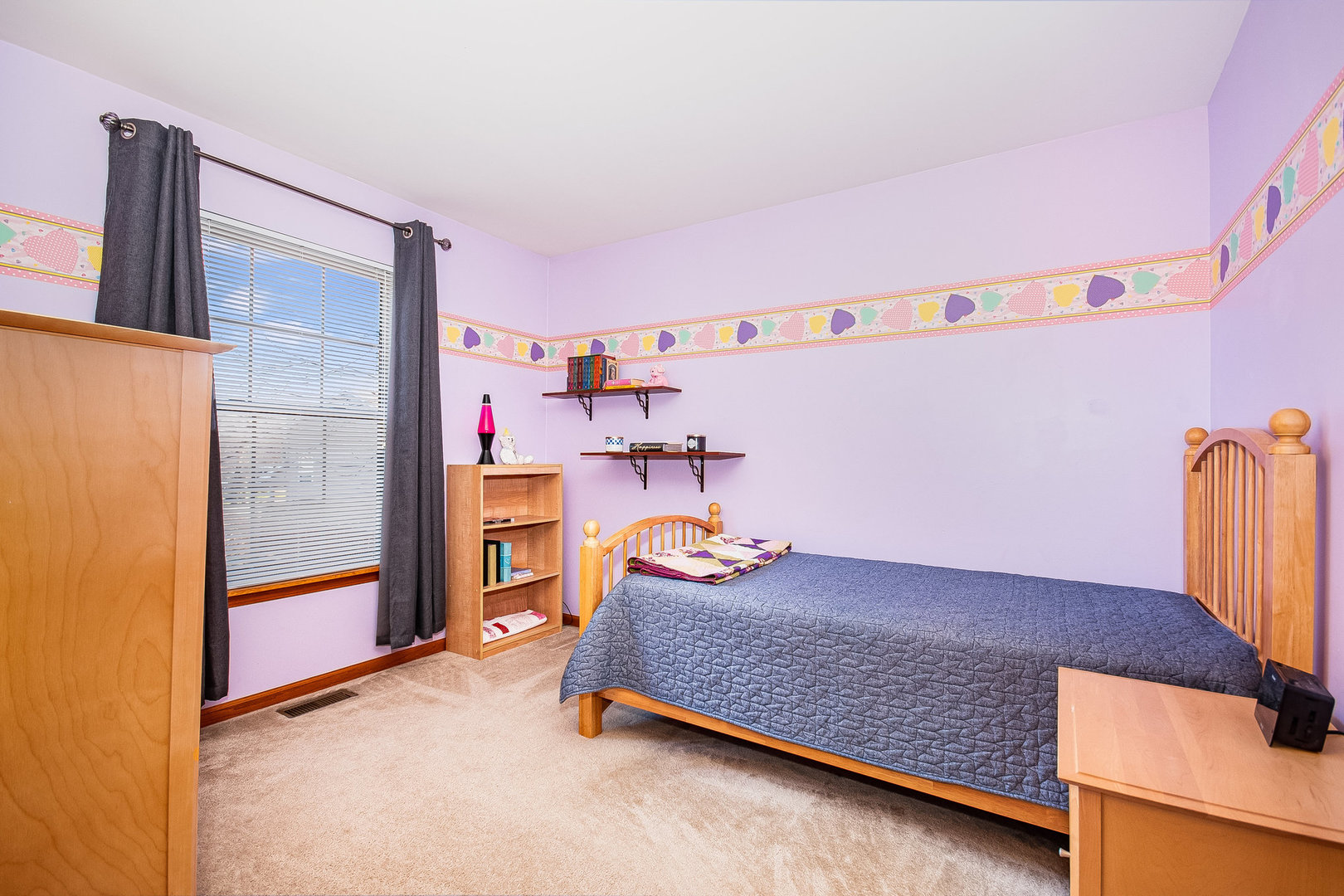 7211 Faxton Lane Plainfield, IL 60586 - Photo 11 of 21 a bedroom with a bed and a refrigerator