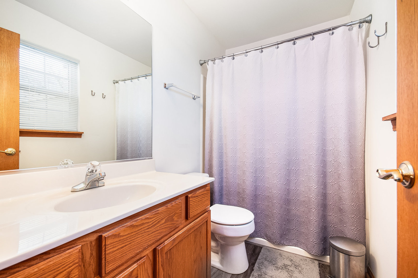 7211 Faxton Lane Plainfield, IL 60586 - Photo 14 of 21 a bathroom with a sink a toilet and shower curtain