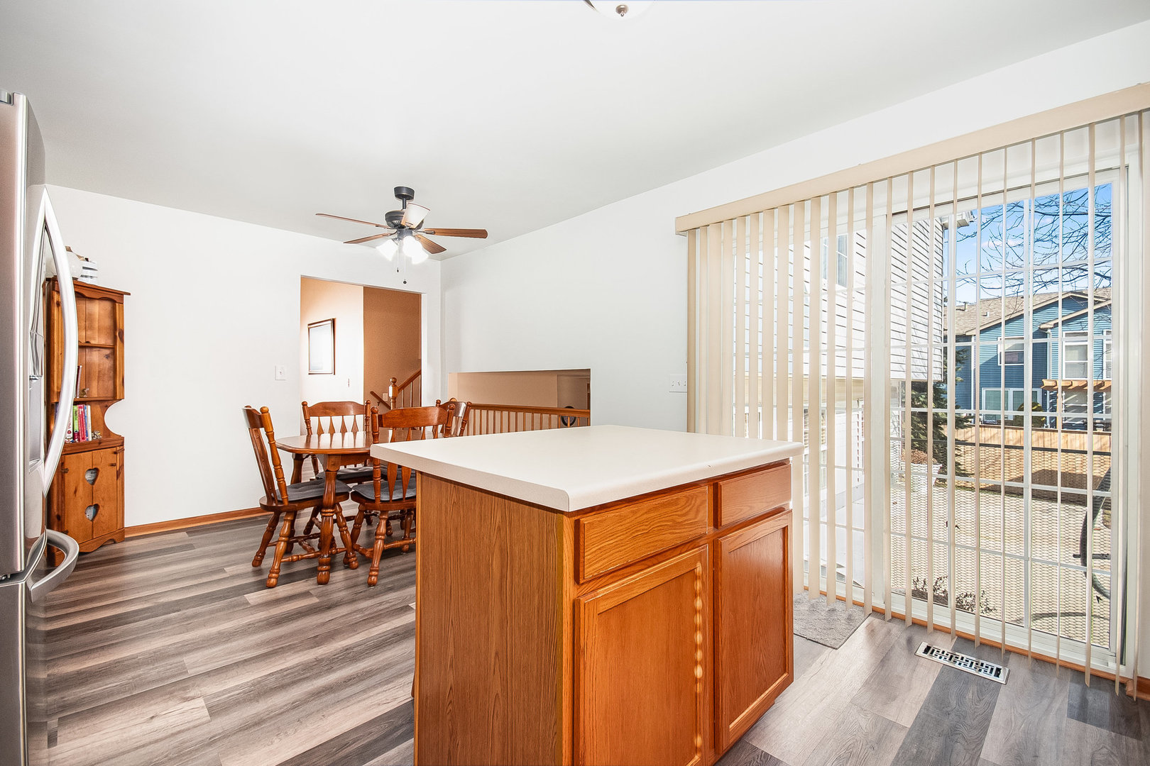 7211 Faxton Lane Plainfield, IL 60586 - Photo 5 of 21 a view of a a dining room with furniture window and wooden floor