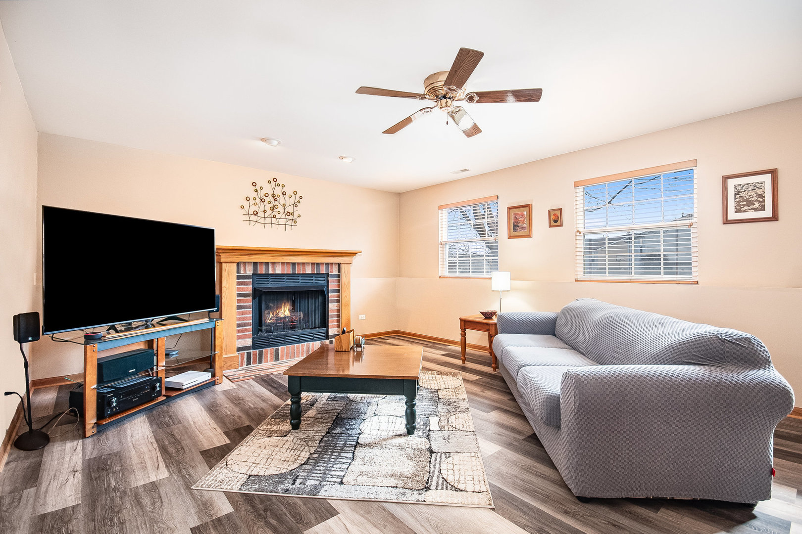 7211 Faxton Lane Plainfield, IL 60586 - Photo 6 of 21 a living room with furniture a flat screen tv and a fireplace