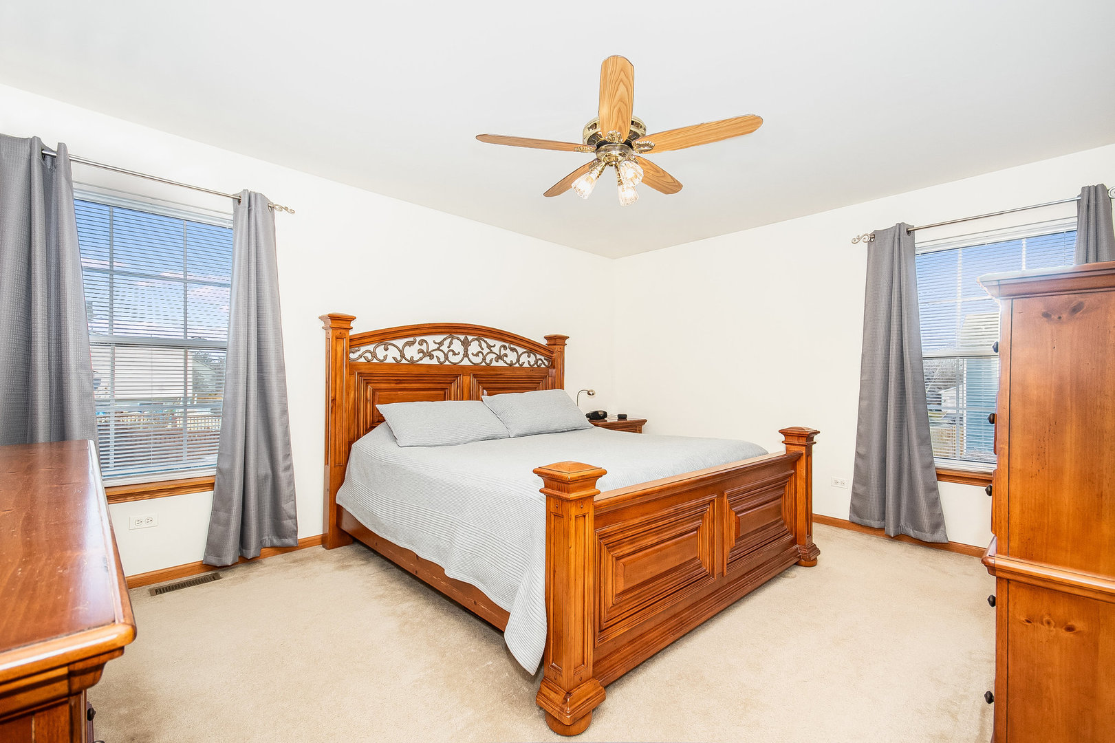 7211 Faxton Lane Plainfield, IL 60586 - Photo 10 of 21 a bedroom with a bed and a chandelier