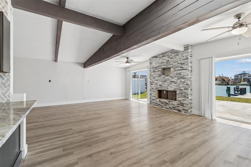 16108 5th Street East Redington Beach, FL 33708 - Photo 12 of 46 a view of a livingroom with wooden floor and a fireplace