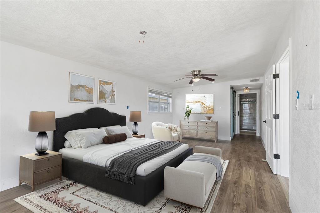 16108 5th Street East Redington Beach, FL 33708 - Photo 19 of 46 a bedroom with a bed and a chandelier
