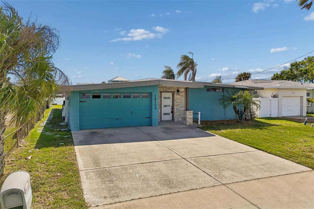 16108 5th Street East Redington Beach, FL 33708 - Photo 2 of 46 a front view of a house with garden