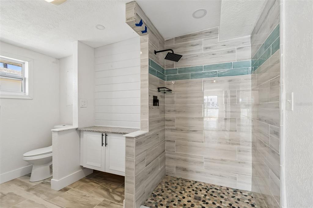 16108 5th Street East Redington Beach, FL 33708 - Photo 21 of 46 a bathroom with a shower and a toilet