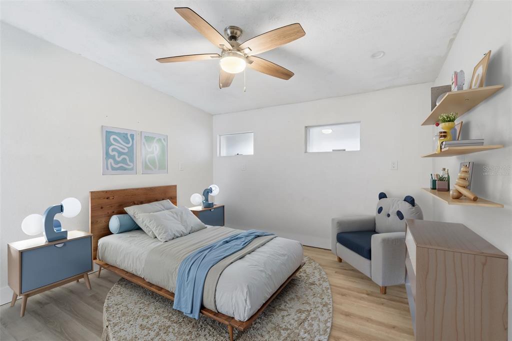 16108 5th Street East Redington Beach, FL 33708 - Photo 24 of 46 a bedroom with a bed and a chandelier