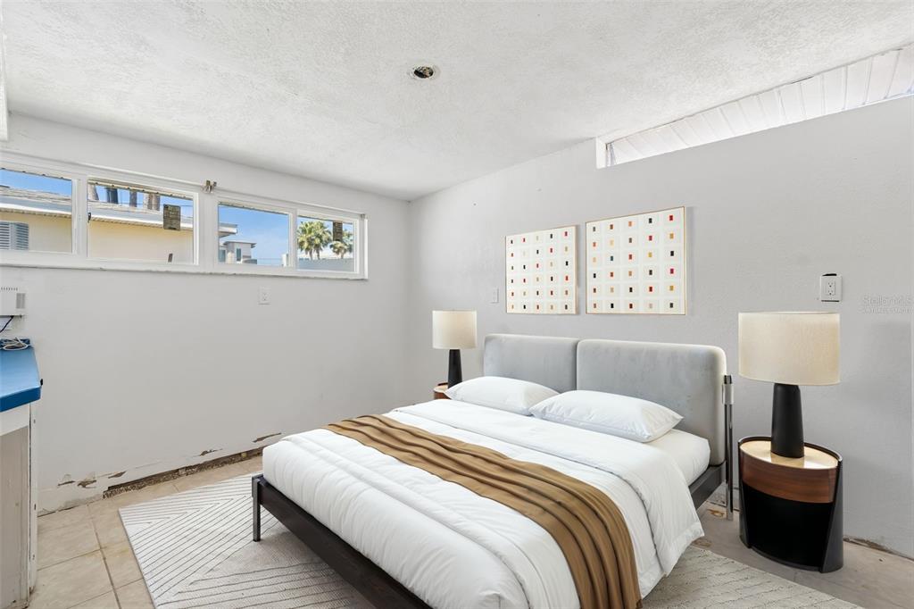 16108 5th Street East Redington Beach, FL 33708 - Photo 28 of 46 a bedroom with a bed and a painting on the wall