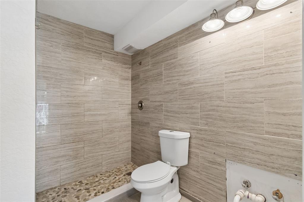 16108 5th Street East Redington Beach, FL 33708 - Photo 30 of 46 a bathroom with a toilet and a shower