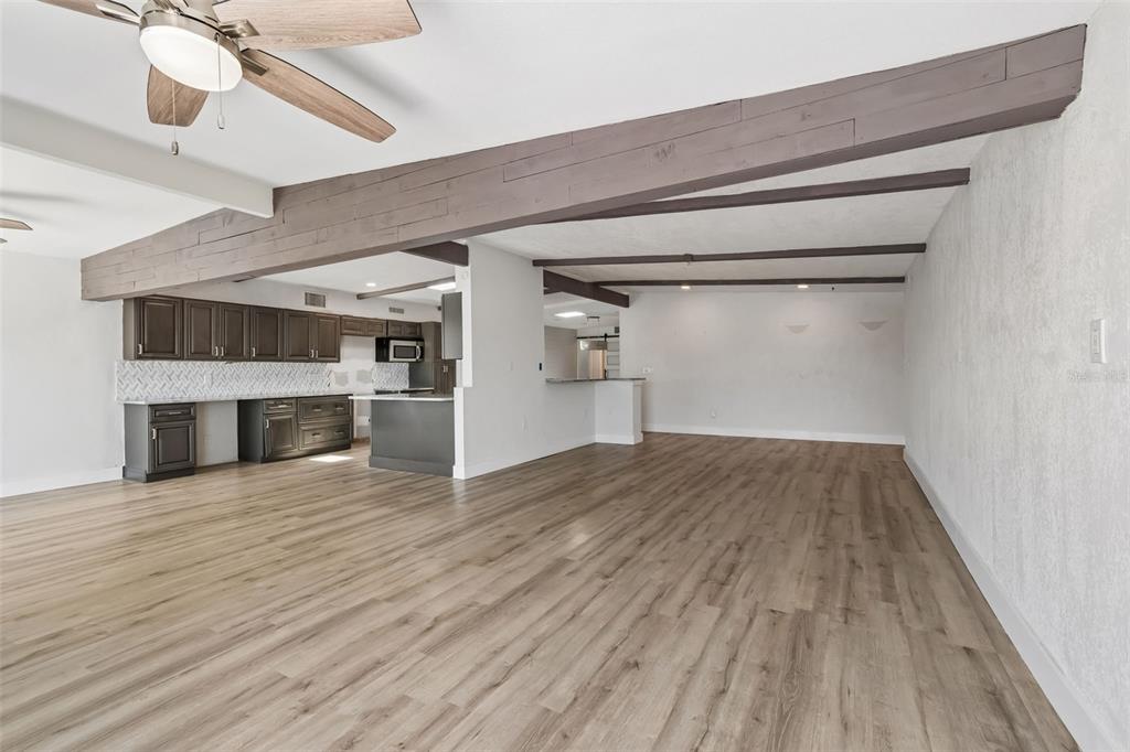16108 5th Street East Redington Beach, FL 33708 - Photo 10 of 46 a view of empty room with wooden floor and fireplace