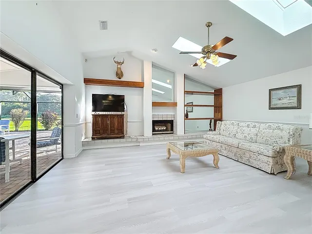 a bathroom with a granite countertop sink a toilet a mirror and shower