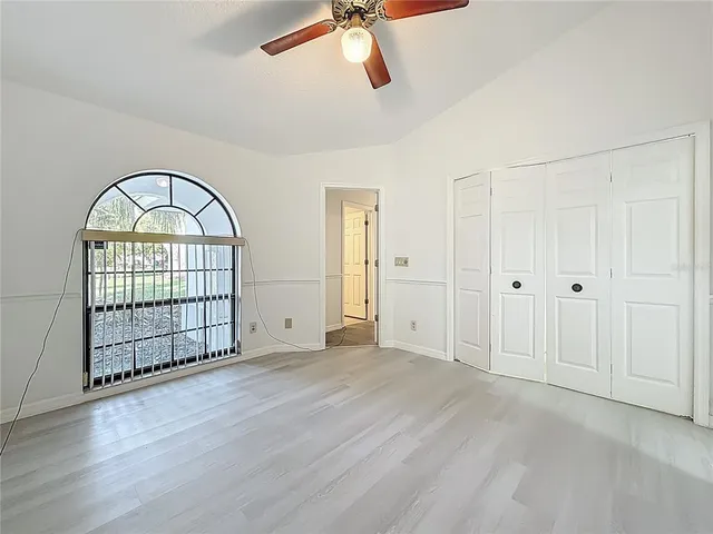 a view of a bedroom with furniture and wooden floor
