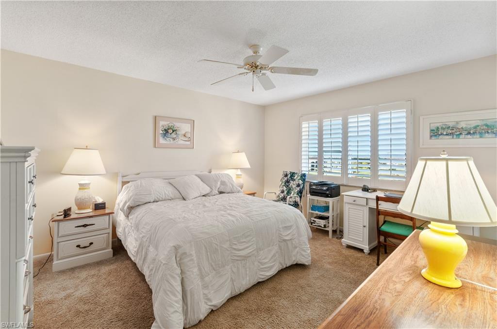 29 High Point Circle East, Unit 508 Naples, FL 34103 - Photo 12 of 35 a bedroom with a bed and a couch