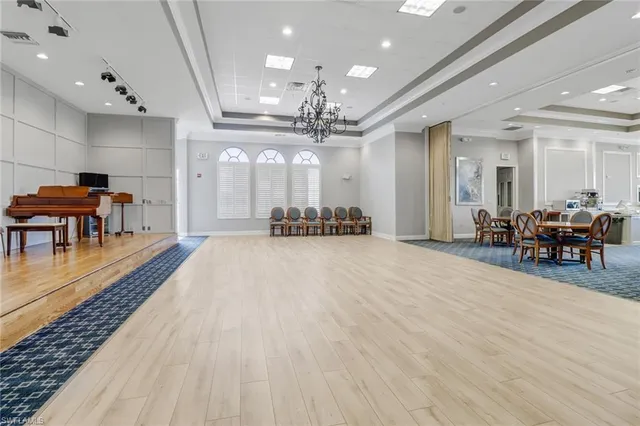a large room with lots of tables a chandelier and livingroom view