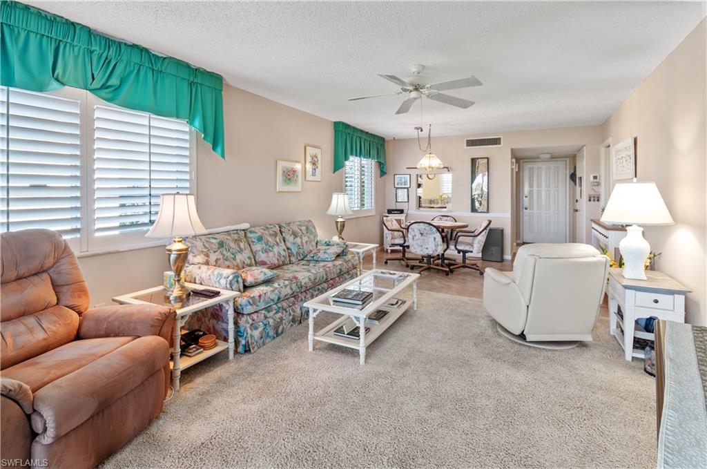29 High Point Circle East, Unit 508 Naples, FL 34103 - Photo 7 of 35 a living room with furniture and a large window