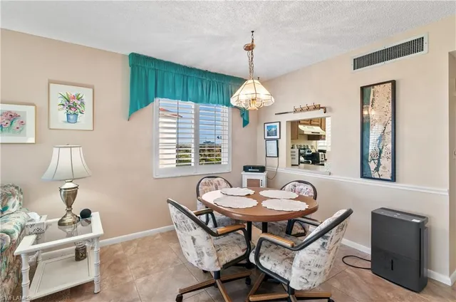 a view of a dining room with furniture and chandelier