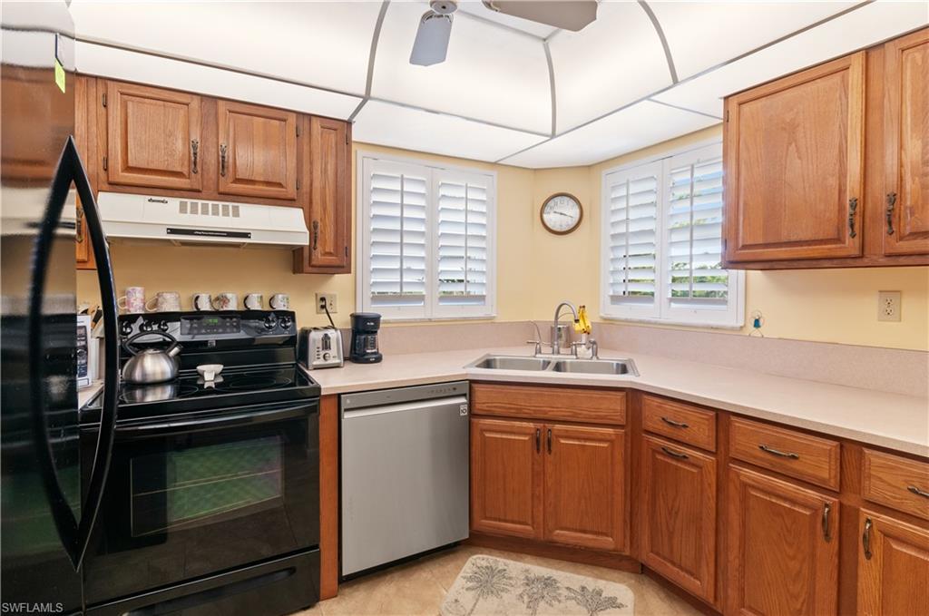 29 High Point Circle East, Unit 508 Naples, FL 34103 - Photo 10 of 35 a kitchen with a sink stove and cabinets