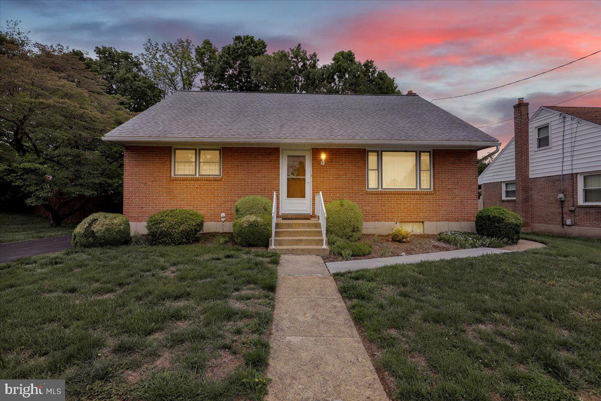 1224 Commonwealth Boulevard Reading, PA 19607 - Photo 2 of 27 a front view of a house with a yard and garage