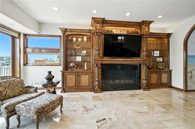 a living room with furniture a rug and a floor to ceiling window