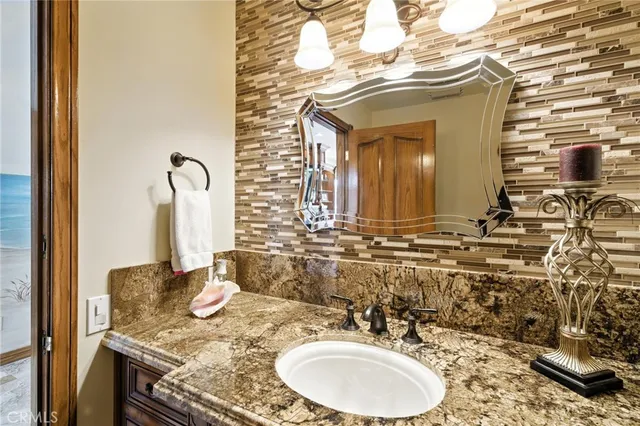 a bedroom with a bed and dresser with mirror