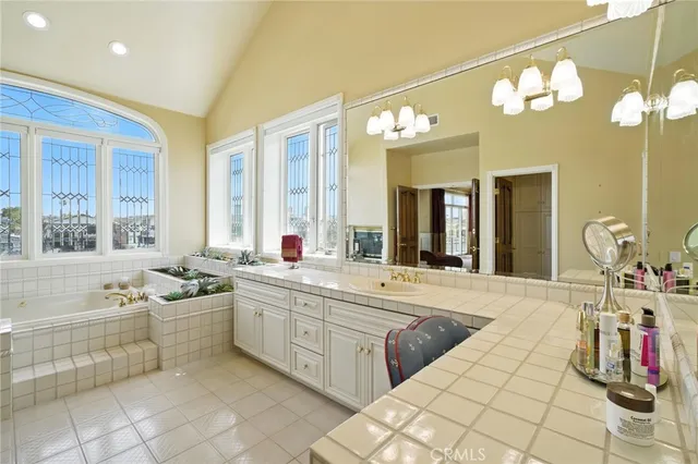 a living room with furniture kitchen view and a wooden floor
