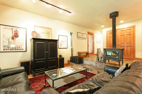 a living room with furniture a rug and a flat screen tv