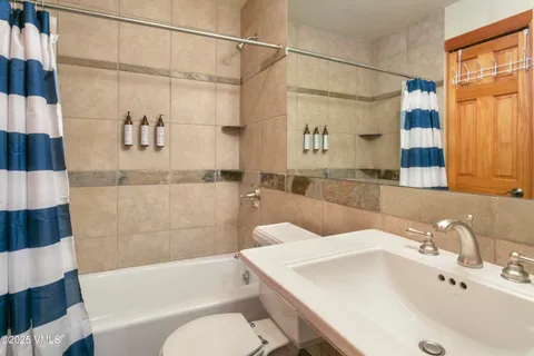 a bathroom with a sink and bathtub with shower
