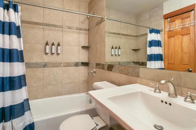 a bathroom with a sink and bathtub with shower