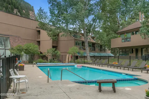 a swimming pool with outdoor seating and yard
