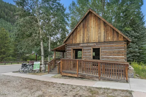a view of a house with a small yard and wooden fence