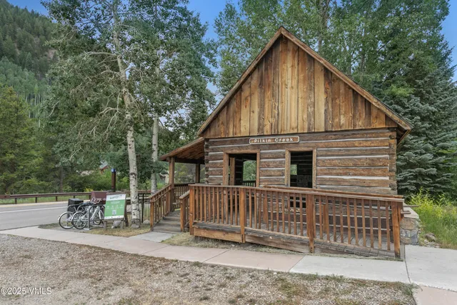 a view of a house with a small yard and wooden fence