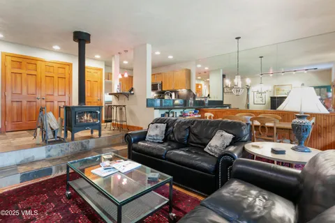 a living room with furniture fireplace and a table