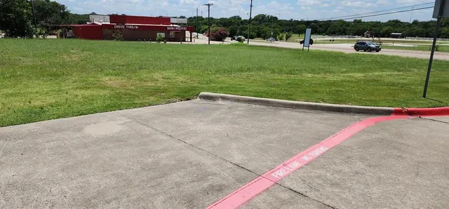 a view of a field of grass and trees