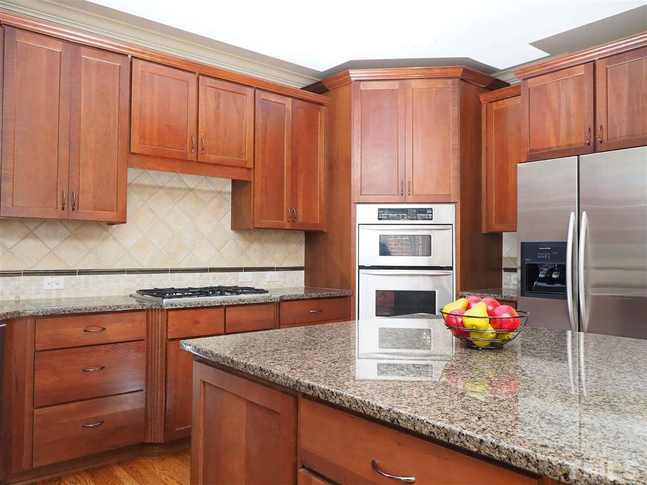 11830 Lowery Ridge Drive Raleigh, NC 27614 - Photo 5 of 30 Tons of cabinets, granite counter-tops with large island and big pantry.