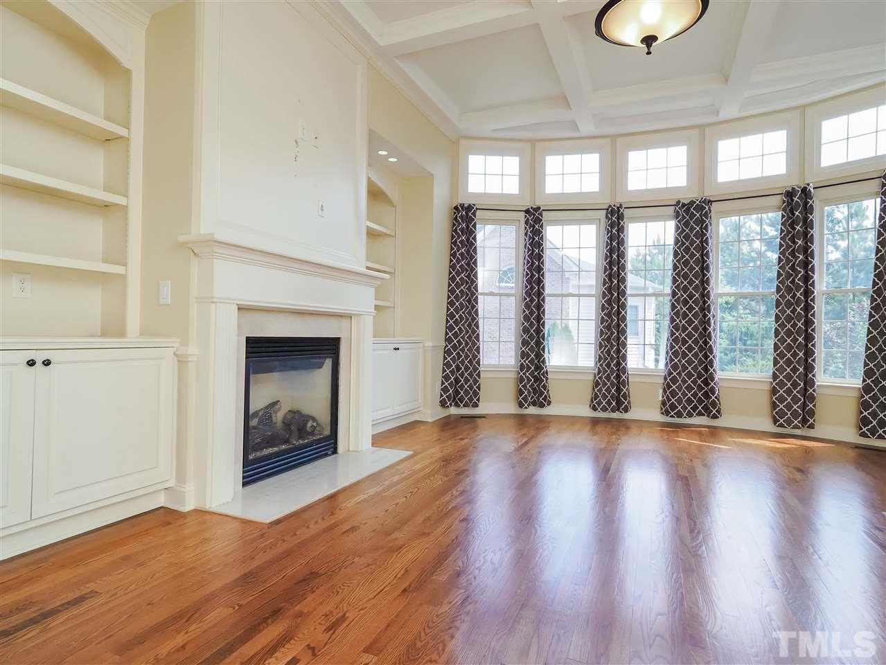 11830 Lowery Ridge Drive Raleigh, NC 27614 - Photo 10 of 30 Custom built-ins and gas log fireplace anchor the family room.