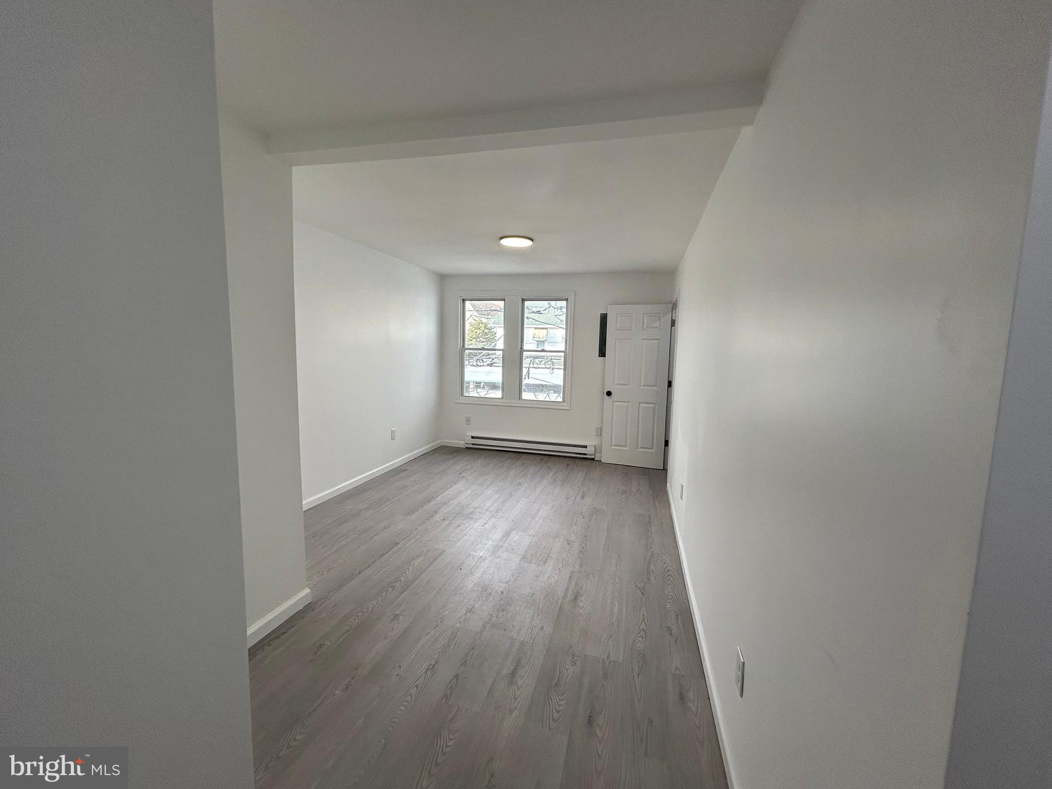 222 West Patterson Street, Unit 4 Lansford, PA 18232 - Photo 2 of 18 an empty room with wooden floor and windows