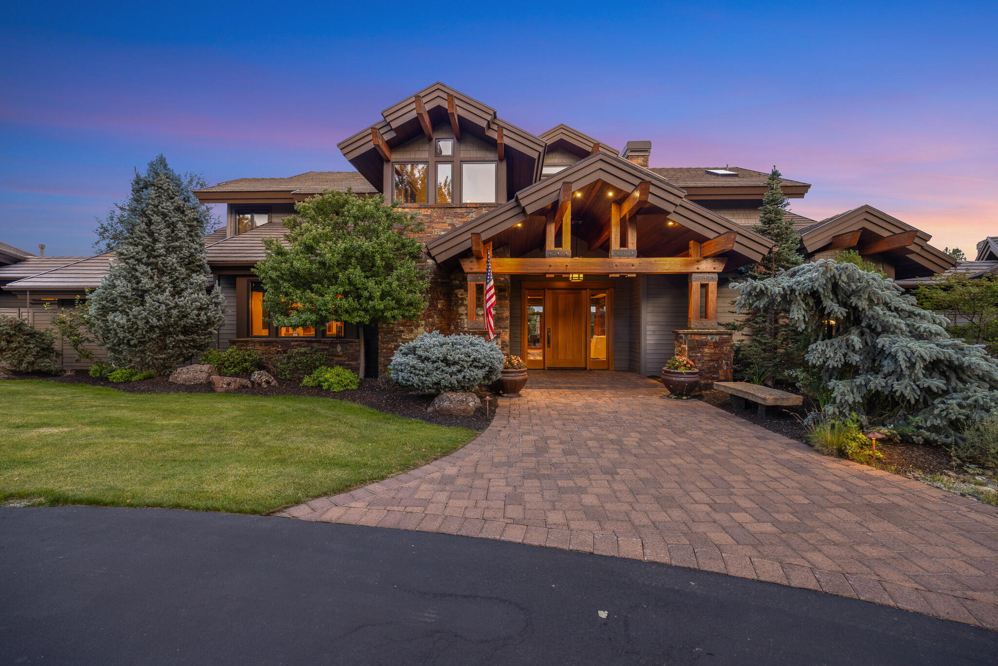 18883 Sutherland Court Bend, OR 97702 - Photo 3 of 70 A grand first impression: custom Norman-built craftsmanship framed by mature pines and timeless Northwest design.