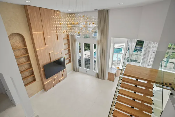 a living room with furniture a fireplace and a chandelier