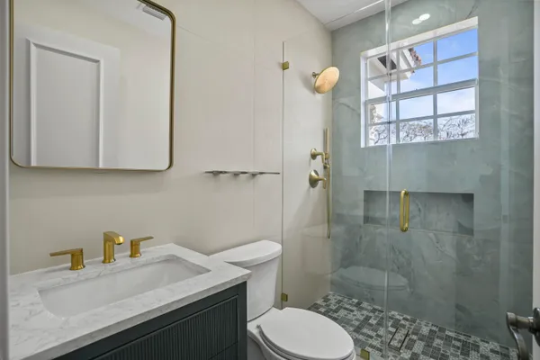 a living room with furniture a chandelier and a table