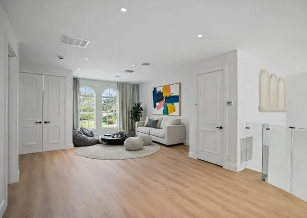 a view of a dining room with furniture and chandelier