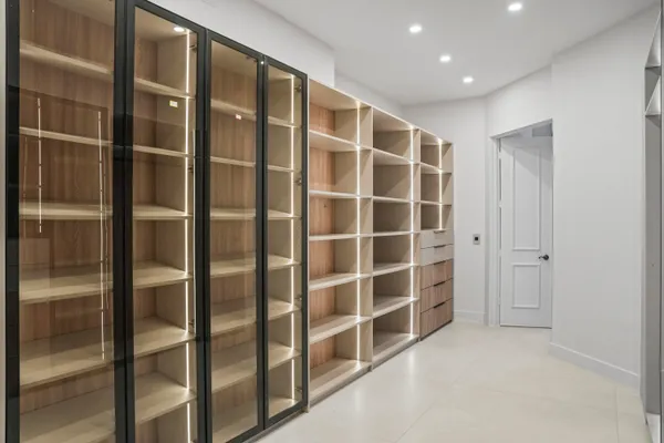 a view of swimming pool with lawn chairs and plants