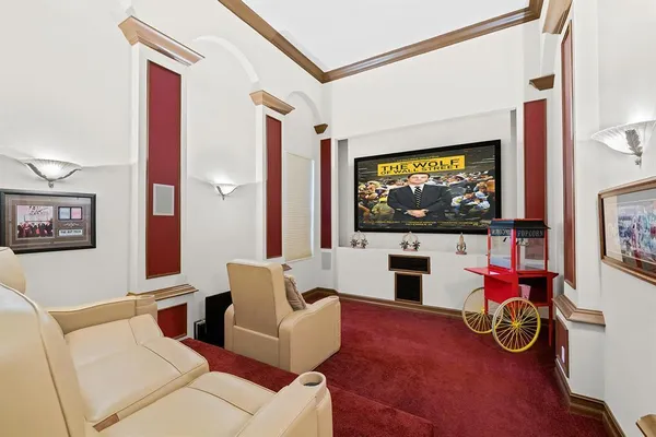 a work room with furniture and a flat screen tv