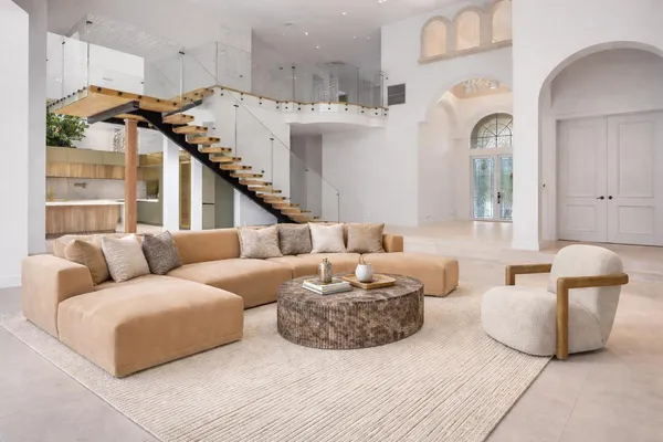 a bedroom with a large bed and a potted plant