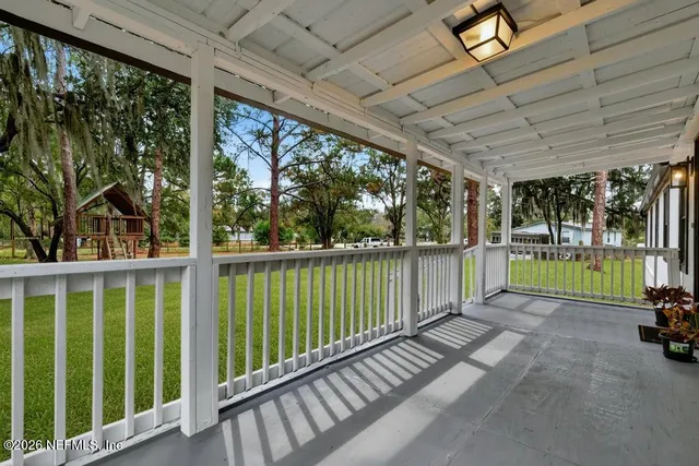 a living room with furniture a ceiling fan and a window