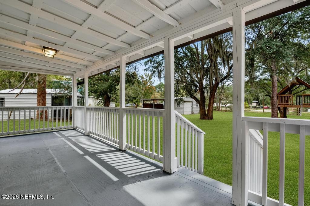 95422 Plum Loop Fernandina Beach, FL 32034 - Photo 12 of 84 a view of a porch with a floor to ceiling window and wooden fence