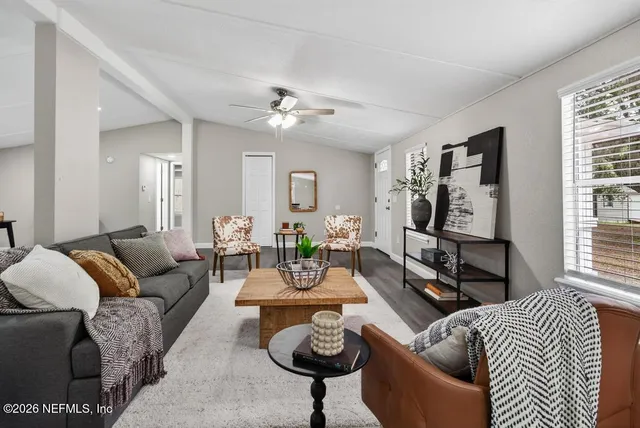 a large kitchen with stainless steel appliances granite countertop a lot of counter space and wooden floor