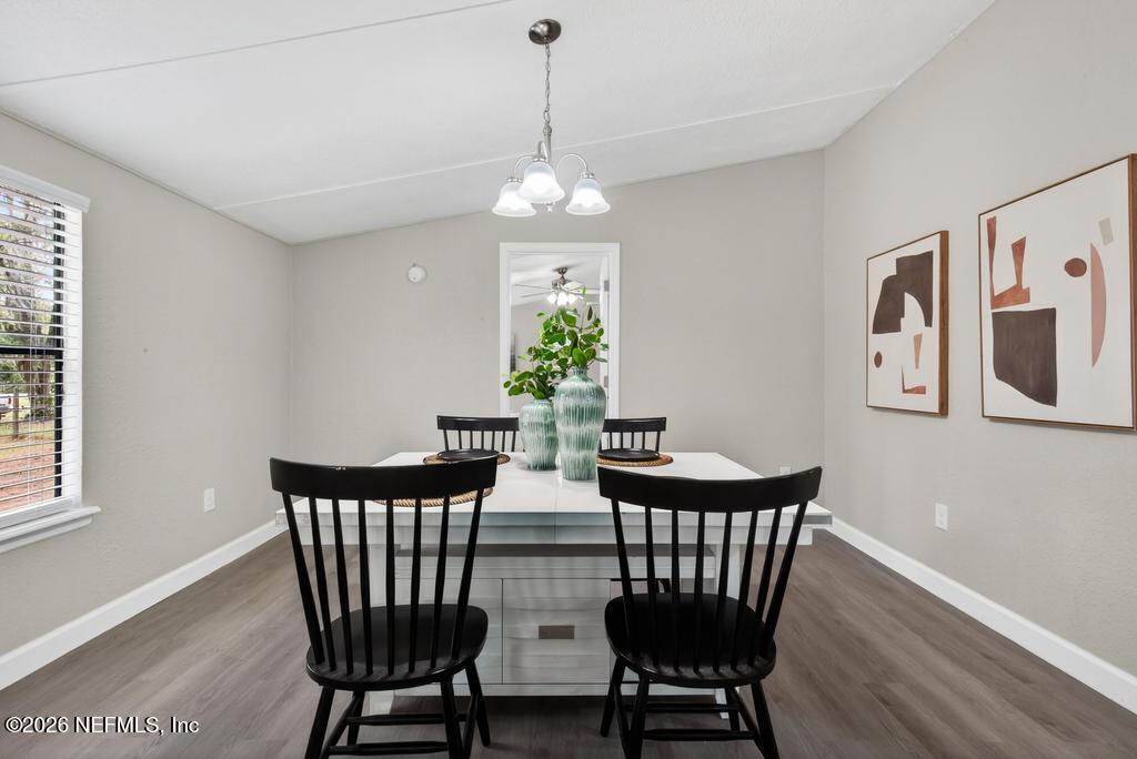 95422 Plum Loop Fernandina Beach, FL 32034 - Photo 23 of 84 a view of a dining room with furniture wooden floor and chandelier